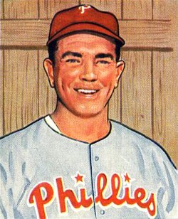 A baseball card image of a smiling man wearing a gray baseball jersey with "Phillies" in red across the chest and a red baseball cap with a white "P" on the front
