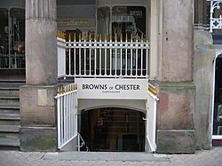 Two columns with a railing between, under which is a stairway leading from the street to a lower level