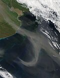 A pale brown plume of dust sweeps out of Argentina's Pampas.