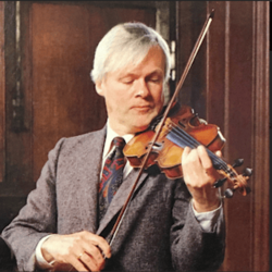 Clean-shaven white man with full head of light-coloured hair, playing a violin