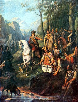 A bison, which was killed on the banks of a stream, is surrounded by a group of people