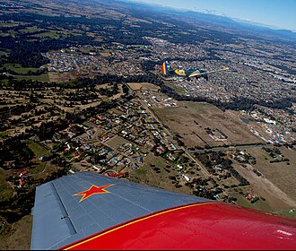 Aerial view from the north-west, Hume Freeway bypass somewhere around top, One and Three Mile creeks meeting around the middle.