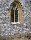 A flint church – the Parish Church of Saint Thomas, in Cricket Saint Thomas, Somerset, England. The height of the very neatly knapped flints varies between 3 and 5 inches (7.6 and 12.7 cm).
