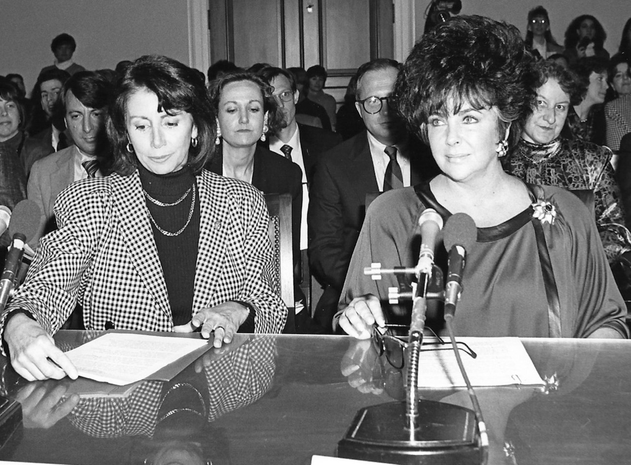 Nancy Pelosi and Elizabeth Taylor Testifying Before the House Budget Committee on HIV-AIDS Funding (5978837887) (cropped).jpg