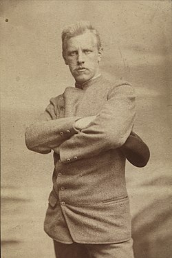 Portrait of a stern and determined looking man with arms crossed.