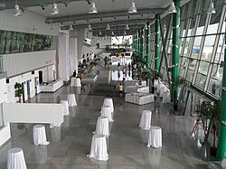 Airport terminal, with small round tables covered with large white tablecloths