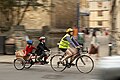 Adult and two children cycling using two-wheeled tandem trailer bike (a Pashley U+2)