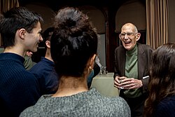 T. M. Scanlon is talking to other students at the Edmond J. Safra Center for Ethics.