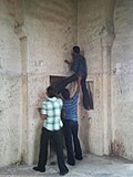 People defacing the walls of the Golconda Fort in Hyderabad, India