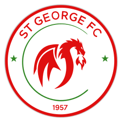 A red and green on white circular badge depicting a dragon breathing fire.