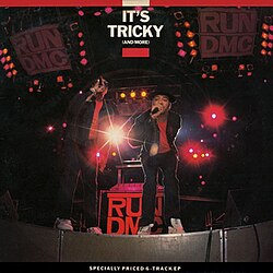 Penn & Teller wearing Run-DMC costumes performing in a stage.