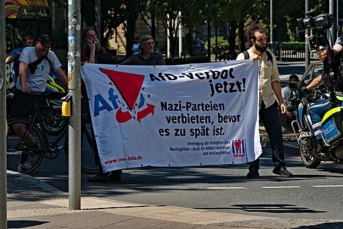 VVN-BdA banner at a protest against Alternative for Germany (AfD) in Frankfurt in 2025. Translation: "Ban the AfD now! Ban Nazi parties, before it's too late".[20]