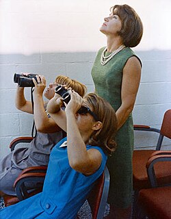 The children survey the sky with binoculars
