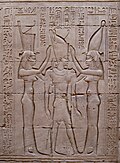 Pharaoh Ptolemy VIII between the goddesses Wadjet (symbolizing lower Egypt) and Nekhbet (symbolizing upper Egypt). Bas-relief on wall of Temple of Edfu, Egypt