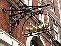 Gresham's initials "TG" and date 1563 with his golden grasshopper emblem, serving as the sign of a bank[10] in Lombard Street, the historic centre of banking in the City of London