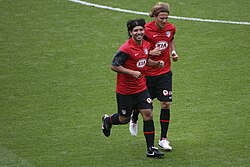 Teammates Sergio Agüero and Diego Forlán training at the Emirates Stadium side by side.