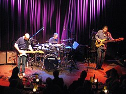 Three musicians performing on stage.