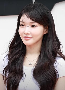 Chung Ha posing on a press photo line for a brand event