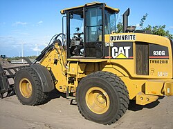 A Caterpillar 930G fitted with a loader rake on a residential construction site in South Florida