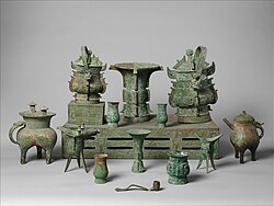 A set of bronze ritual vessels arranged in a museum display