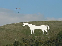 Figure of a white horse cut into the hillside.