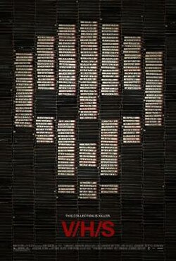 Stacks of black VHS tapes, some with white labels that come together to form a skull shape.