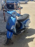 A small blue italian scooter type motorcycle