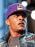 T.I. performing live on stage wearing a cap.