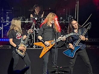 A four-piece band performing onstage