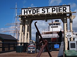 An overhead structure labeled "Hyde St. Pier" frames a historic ferryboat alongside a US 101 shield and older sailing ship.