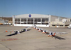 two craft in front of an aircraft hall