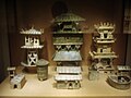 Among a large set of architectural models, three Eastern Han dynasty watchtowers stand in the rear of this display.