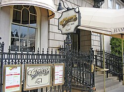 Sign reading, "Cheers est. 1985" highlighted by a manicule