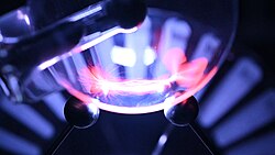 Lichtenberg figures are generated by a sliding spark discharge on the flask with a mixture of gases. Structural differences between the "positive" and "negative" figures can be observed.