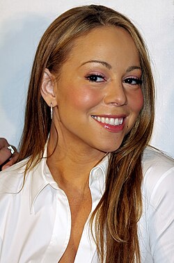 Mariah Carey slightly smiling, looking to her left hand side.