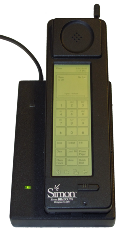 Photograph of the Simon Personal Communicator shown in its charging base