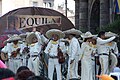 Mariachis on stage in Guadalajara in front of a Tequila Express banner