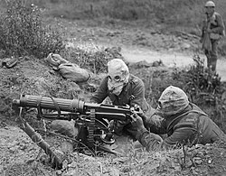 British Vickers gun team in action at the Battle of the Somme. Both are wearing gas masks.