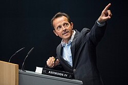 Patrick Michel, photographed with his book Asteroid IV.