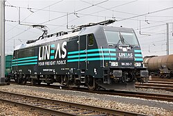 Electric locomotive in grey livery with turquoise stripes