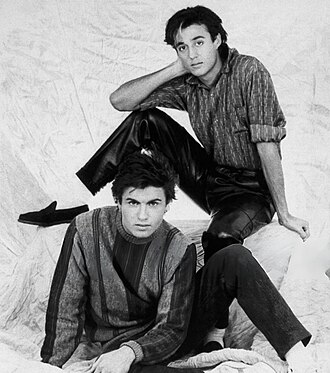 A black-and-white photograph of the members of the English pop duo Wham!, circa 1985.