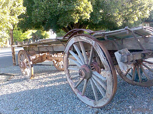 Ox-wagon with four wagon wheels.