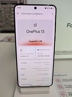 The front of the OnePlus 13 running OxygenOS 15.0 with opened "About device" settings