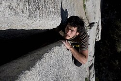 A climber doing the body jamming technique