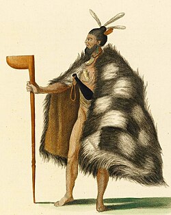 An indigenous Māori man from New Zealand, wearing a cloak and holding a club