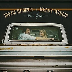 A photograph of Robison and Willis seated in a pickup truck, looking at the camera in the rear