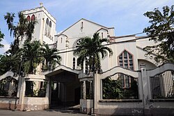 A tan church exterior with palm trees (Knox United Methodist Church)