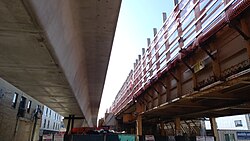 Red and Purple Modernization construction at Lawrence Avenue, showing older embankment and newer box-girder tracks side-by-side