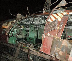 A color photograph of a railway coach blown apart from the middle