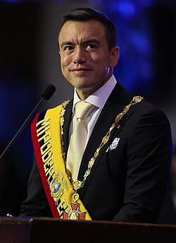 Headshot of Daniel Noboa. He is a clean-shaven, Latino man with very short hair, wearing a suit with a tie.